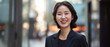 © 168 STUDIO - Young Asian businesswoman Energetic and smiling professional woman in business attire enjoying the city atmosphere at sunset.