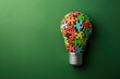 Light bulb consisting of coloured puzzles on a coloured background, idea concept