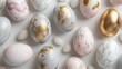  a close up of a bunch of eggs with gold flecks and marbled ones on a white surface.
