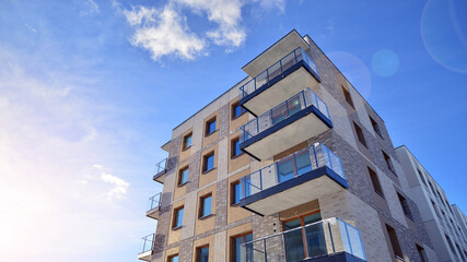 Modern apartment building in sunny day. Exterior, residential house facade. Residential area with modern, new and stylish living block of flats. 