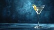  a close up of a martini glass with a lemon garnish on the rim and a dark blue background.