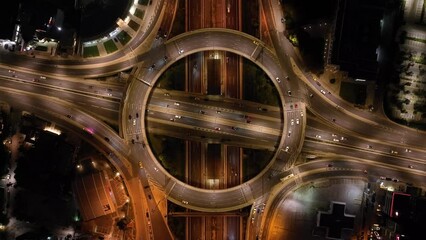 Wall Mural - Aerial drone night cinematic video of illuminated urban elevated toll ring road junction and interchange overpass passing through Kifisias Avenue, Attica, Greece