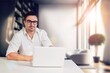 © BillionPhotos.com - Smiling young businessman working in office
