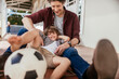 © Marko Geber - Father and son laughing and relaxing with a soccer ball on the porch