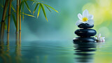 Fototapeta Kwiaty - Zen balance: black stones, bamboo, and water reflection with a touch of floral grace