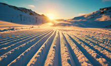 Sunrise Over Freshly Groomed Ski Slopes In A Winter Landscape.