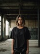 editorial style photograph of a model wearing an oversized blank black vintage distressed faded t-shirt in an old abandoned urban warehouse, shot on film, 16mm, grain, noise, photography, depth of fie