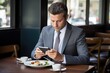 © Andrii - Man Sitting at Table, Looking at Cell Phone, Technology, Communication, Recreation