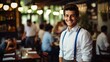 Portrait of a happy young male waiter in a restaurant