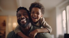 Happy Black Father And Son Playing On Blurred Background Of Living Room