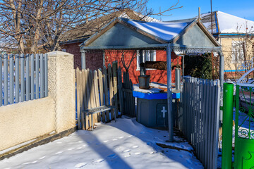 Wall Mural - Well in a winter village. Background with selective focus and copy space