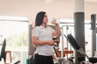© Hugo - Trainer drinking water in the gym.