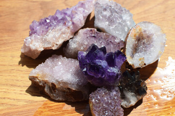 Wall Mural - Beautiful purple druzy with amethyst crystals on a wet wooden background. Magical semi-precious stones.