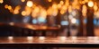 © Sona - Wooden table on a blurry cafe background with golden lighting at night, ideal for showcasing products or designing visual layouts.