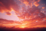 Fototapeta Zachód słońca - A close up of a vibrant and colorful sunset sky, with the sun barely visible in the horizon and the sky filled with deep oranges and pinks