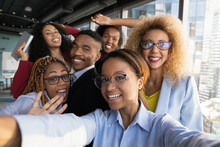 Office Selfie. Friendly Young Biracial Workers Colleagues Have Fun At Workplace Shoot Cute Silly Self Picture On Phone. Active Millennial Black Business Team Take Funny Group Photo For Corporate Blog