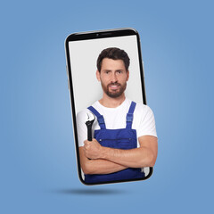 Poster - Plumber looking out of smartphone on light blue background