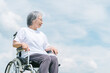 青空と車椅子に座る高齢者・シニア女性（介護・車椅子・おばあちゃん・デイサービス）
