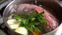 Stuffed Flank Steak In Pot With Water And Parsley For Boiling. Cooking Matambre Arrollado. Closeup Shot