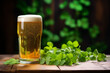 A glass of beer on a wooden table with leaves. St. Patrick's Day background