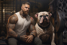 Muscular, Tattooed Man With His Robust And Strong Bulldog In A Gym Environment