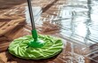 clean floor on a wooden floor with green mop