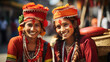Two joyful Nepali women in colorful traditional attire with floral headpieces share a moment of laughter.