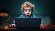 © red_orange_stock - A young child shows a shocked expression while using a laptop in a dark room, highlighting the impact of technology on youth.