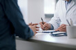 © StockPhotoPro - Doctor writing a medical prescription for his patient