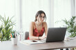 © StockPhotoPro - Student sitting at desk and working with a laptop