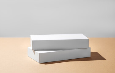 Wall Mural - Empty podium for product. Minimal two white boxes on a beige background with hard shadow.