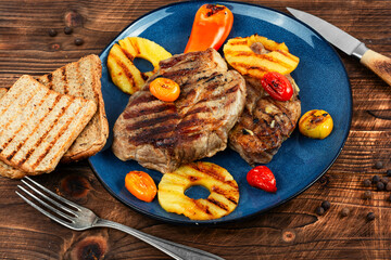 Canvas Print - Pork steak with pineapple on plate.