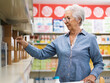 © StockPhotoPro - Senior woman buying groceries at the supermarket
