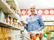 © StockPhotoPro - Happy senior woman buying groceries at the store