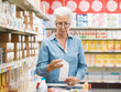 © StockPhotoPro - Disappointed senior customer checking the grocery receipt