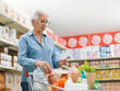 © StockPhotoPro - Senior woman checking her grocery list at the supermarket