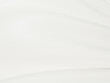 © DigitalFuturistic - Wedding white gold fabric silk luxury smooth waving cloth soft background. Abstract wavy satin pastel color for elegant design wallpaper.