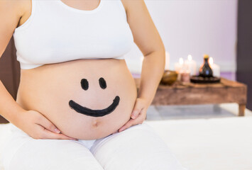 Canvas Print - Young pregnant woman have massage treatment at spa