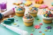 decorating cupcakes with colorful icing and sprinkles