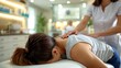 Professional manual therapist treats a girl lying on a massage bed. A Modern rehabilitation physiotherapy.