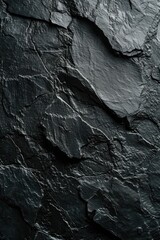 Poster - A detailed view of a black stone wall. This image can be used to add texture and depth to design projects