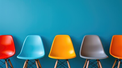Poster - A row of colorful chairs placed against a vibrant blue wall. This versatile image can be used to add a pop of color and vibrancy to various design projects