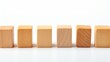 Row of small natural wooden blocks on white background for text placement and copy space