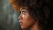 Profile portrait of beautiful curly african american woman over gray background
