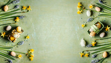 Green Easter Background With Springtime Flowers And Easter Eggs, Top View. Frame