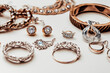 bijouterie. earrings, rings, brooches and necklaces lie on a white table, close-up. costume jewelry concept