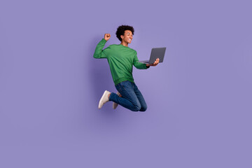 Wall Mural - Full length photo of funky lucky guy wear green pullover winning apple samsung gadget jumping high isolated purple color background