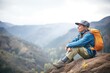 hiker resting on a boulder with canyon backdrop