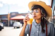 woman sipping club soda through a straw outdoors
