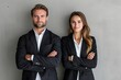 © senyumanmu - Businessman and woman posing in front of gray background